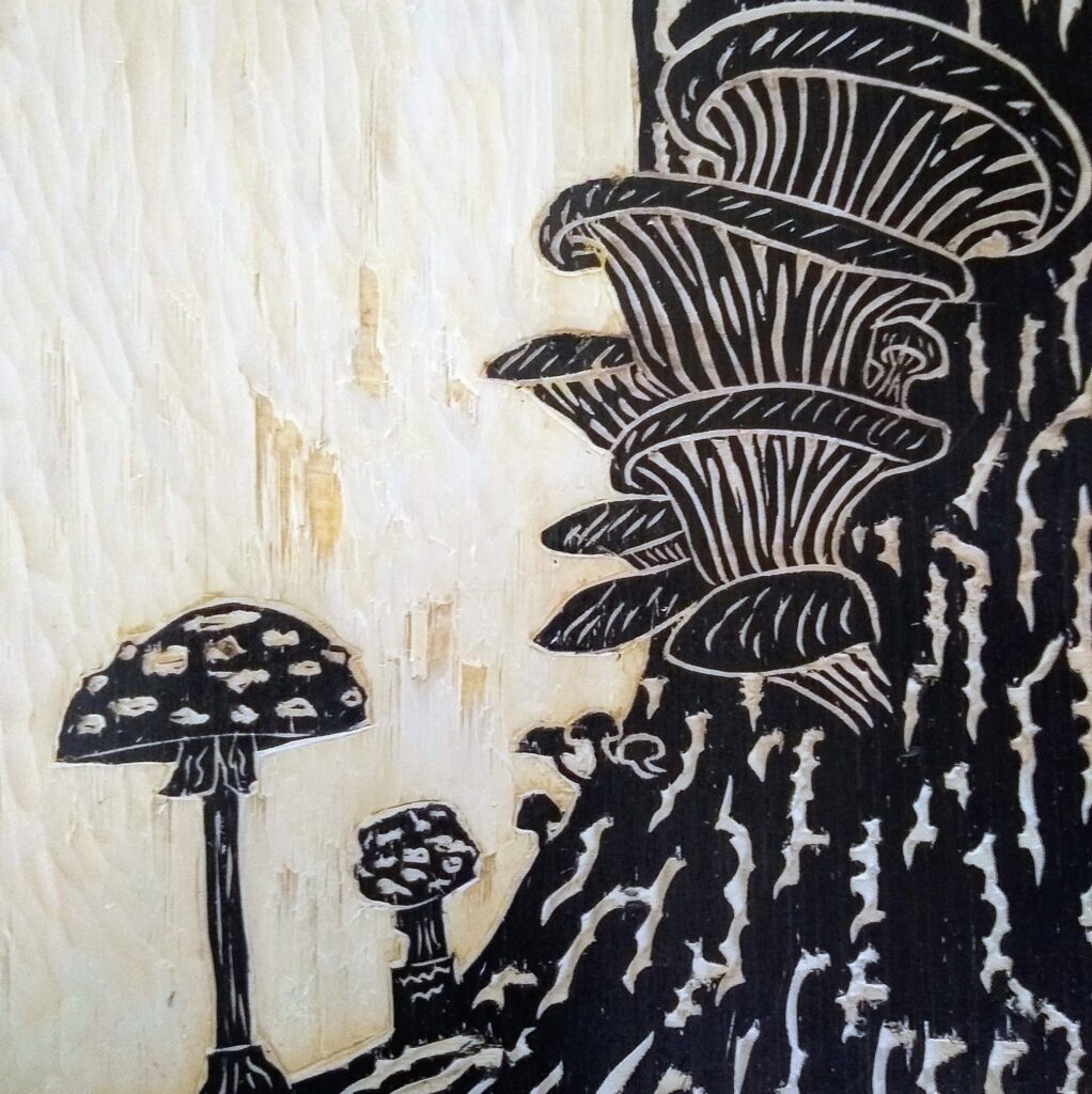 Wood art depicting varioOrnate woodblock art depicting flora and fauna, made by Savannah Freeman.us types of mushrooms growing from a tree stump.