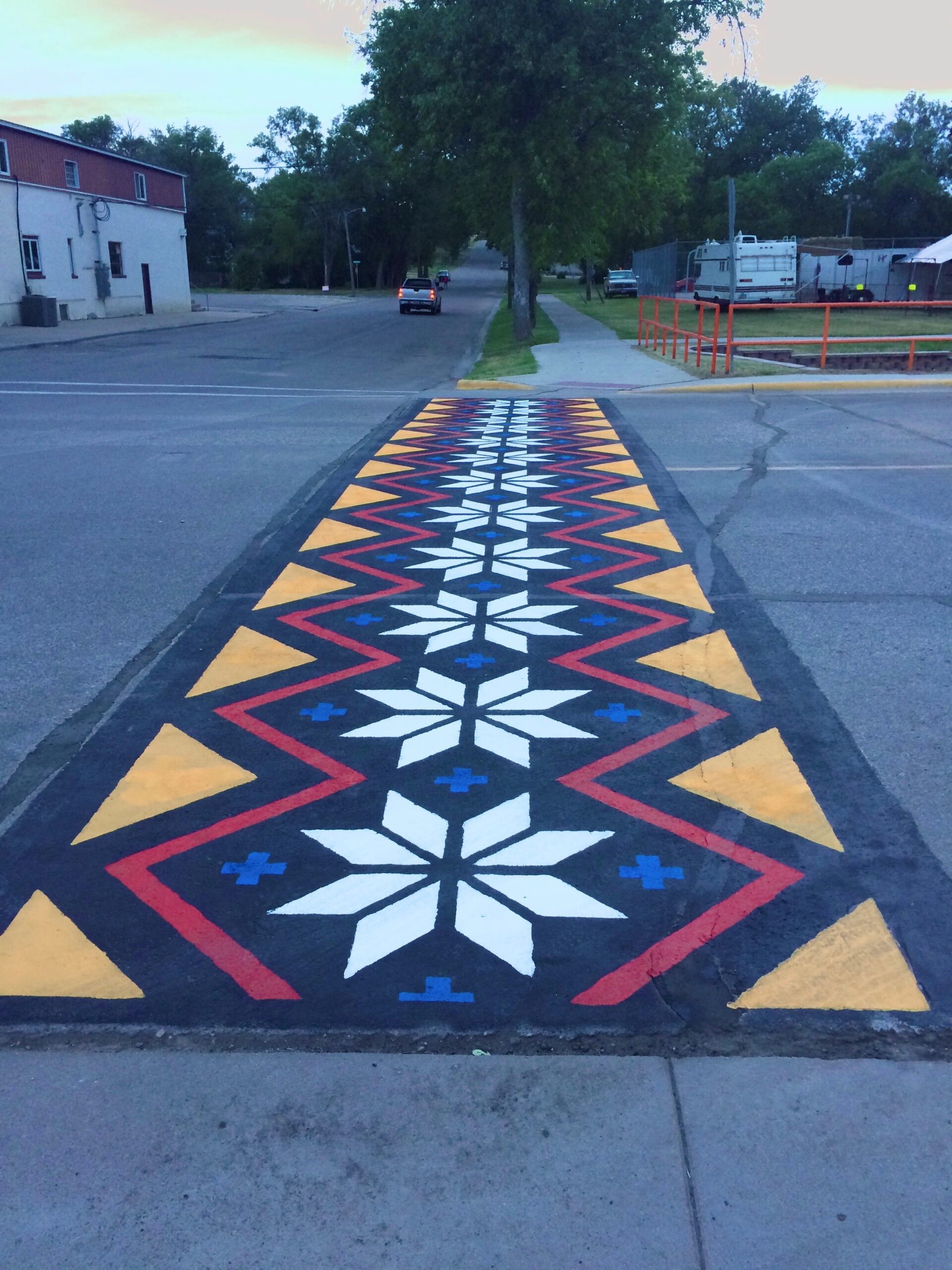 Crosswalk mural featuring a repeating 8 point star design.