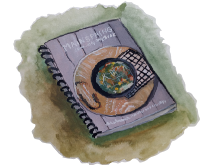 Illustration of a spiraled cookbook with the title "Mainspring Community Cookbook"