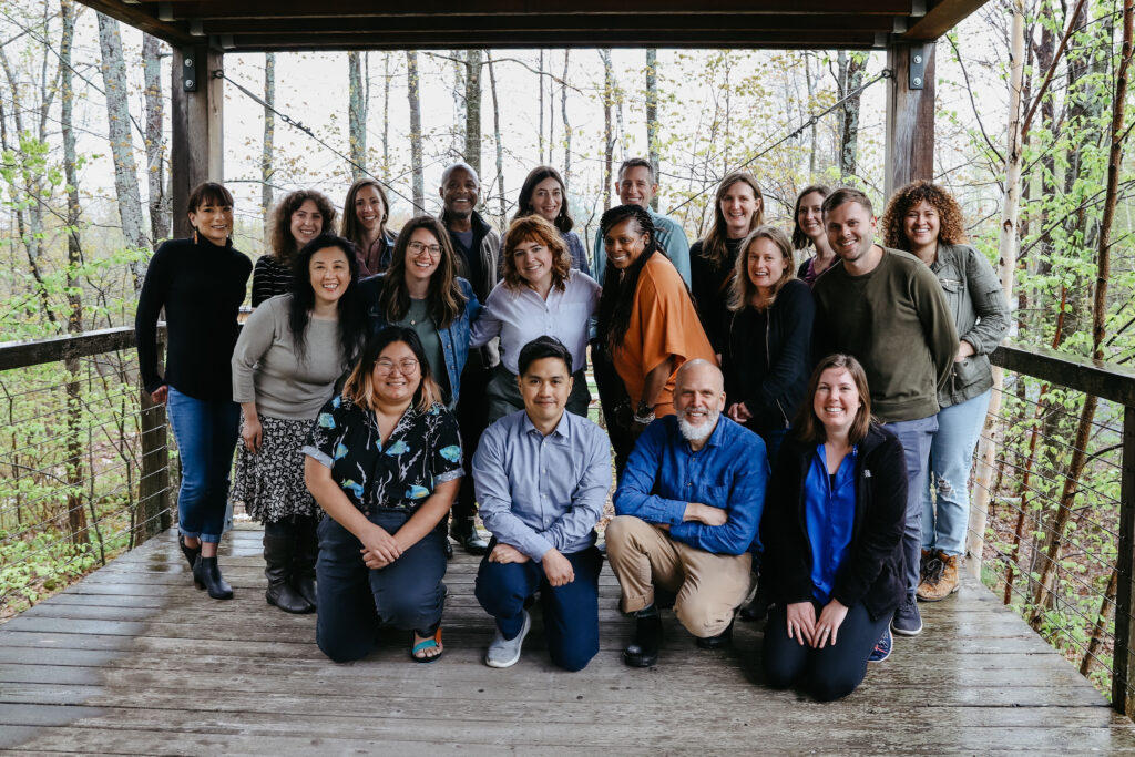 Arts Midwest staff pose for a group photo at their 2022 staff retreat at Wild Rice Retreat Center in Bayfield, WI.
