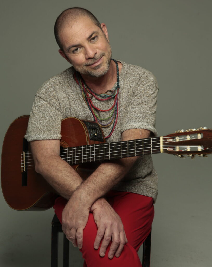 Paulo Padilha e Bando, a samba swing artist from Brazil, poses with his guitar.