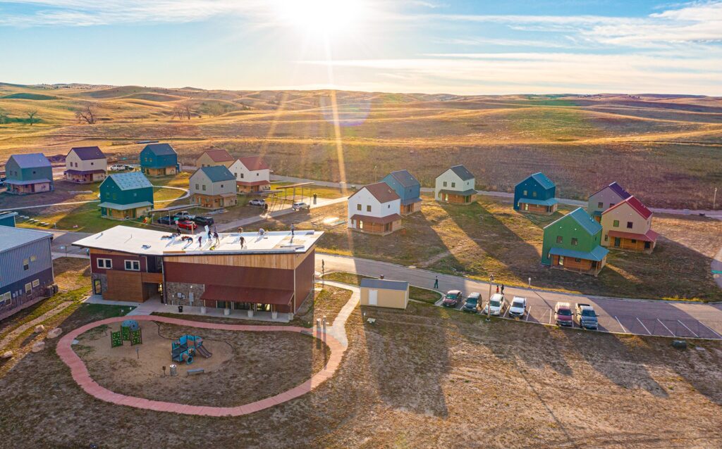 A drone shot of Thunder Valley Community Development Corporation. The sun is shining brightly and casting shadows from the buildings.