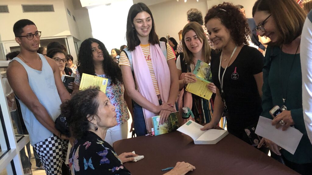 Students getting their books signed by Julia Alvarez.
