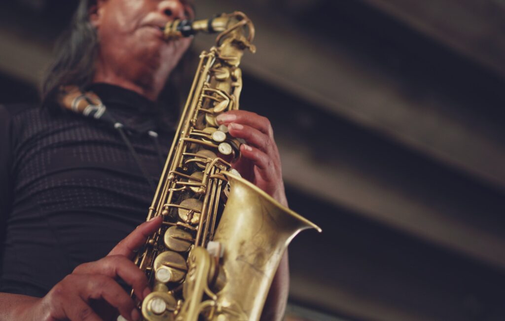 Close up on a person playing a saxophone.