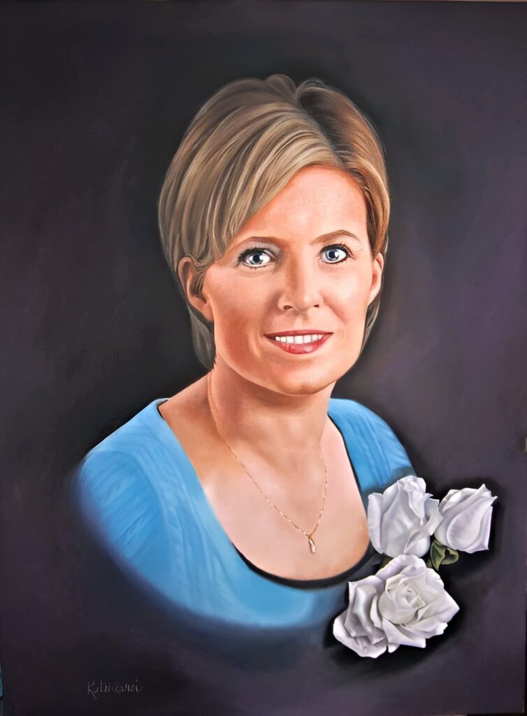 A painted portrait of a smiling woman with short blonde hair in a blue shirt. Three white roses bloom in the foreground.
