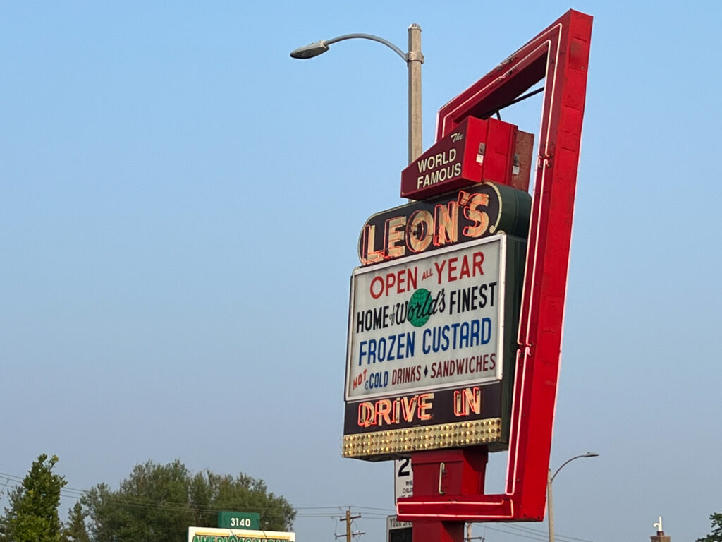 A colorful sign reading "Leon's Drive-in, Home of the World's Finest Frozen Custard"