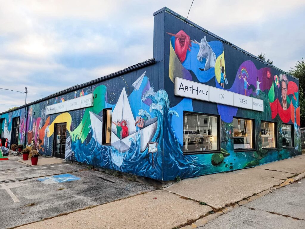 A view of the exterior of ArtHaus, showing a vibrant painted mural