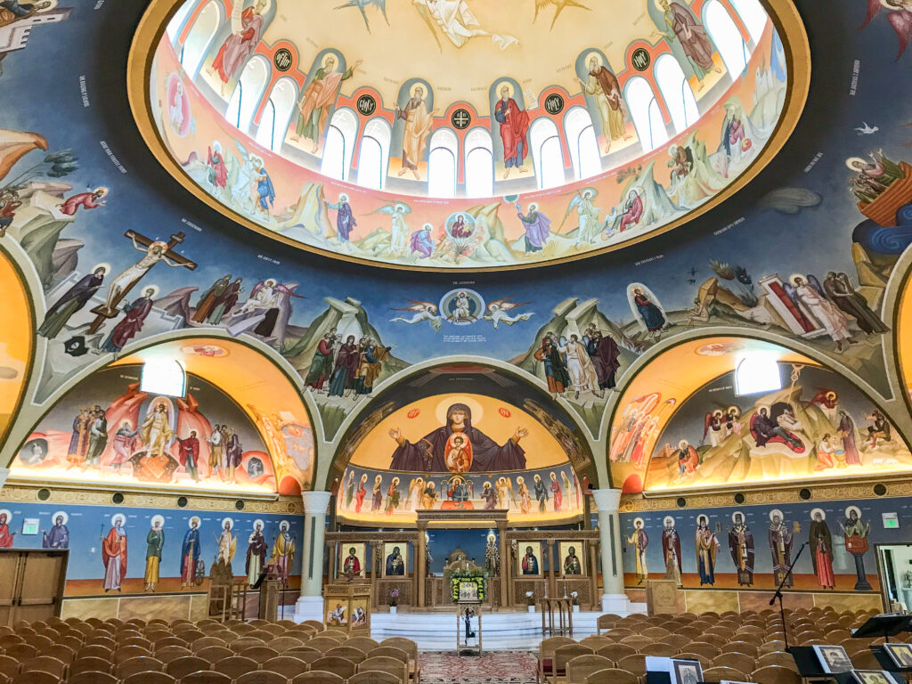 A beautiful mural of saints on the domed ceiling of a church