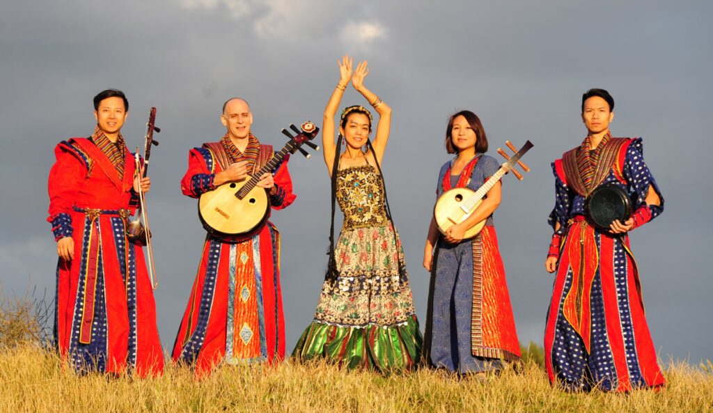 Five people in traditional Taiwanese dress, holding various instruments