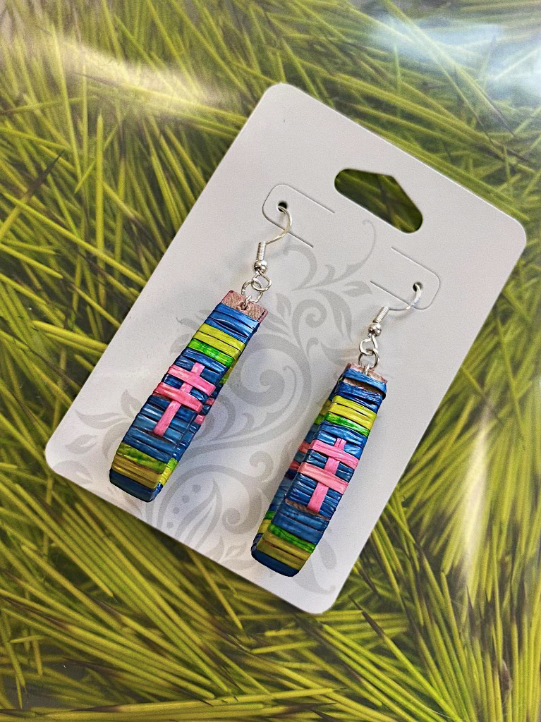 A pair of colorful earrings made of porcupine quill dyed in shades of blue, green, yellow, and pink.