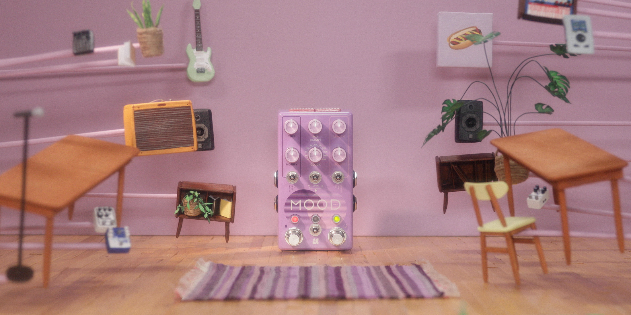 A pink guitar pedal is surrounded by miniature furniture and decor, including speakers, an amp and an electric guitar.