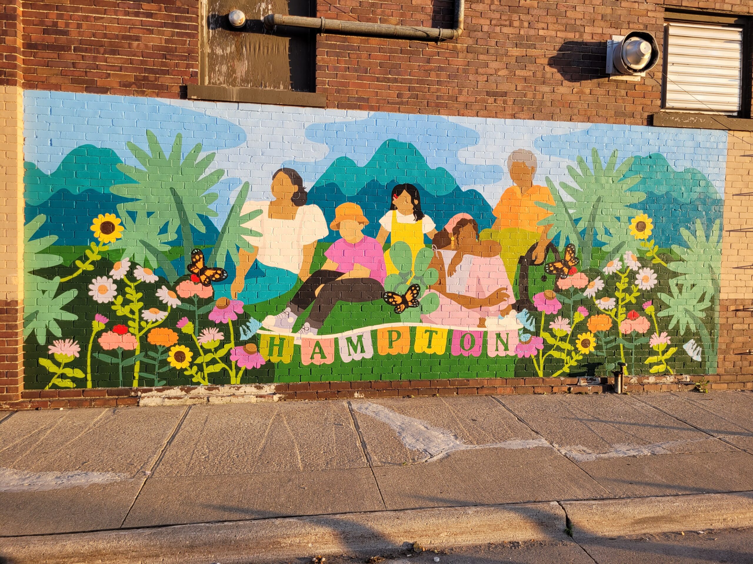 A mural showing people and beautiful flora.