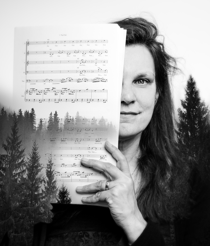 A black and white image of a person with long hair holding up pages of sheet music. There is an image of evergreen trees overlaid on it.