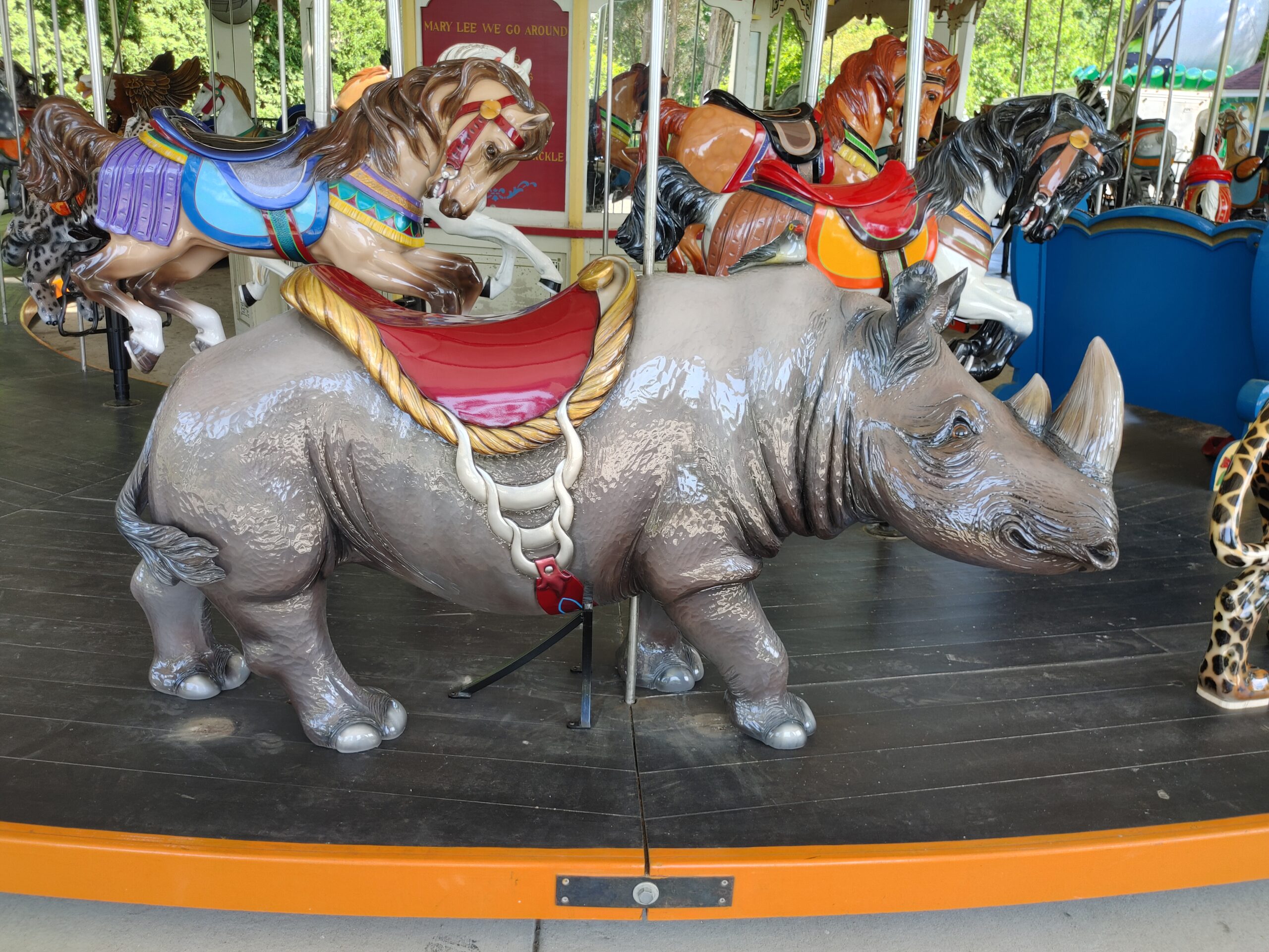 An elaborately carved rhinoceros on a carousel.