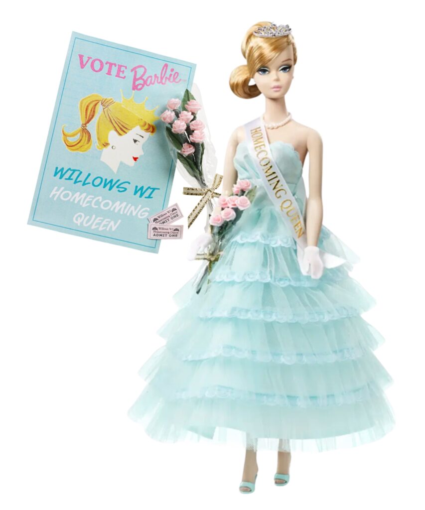 A Barbie doll wearing a blue floor-length gown and a sash reading "Homecoming Queen," along with a flower bouquet and a poster reading, "Vote Barbie Willows, WI Homecoming Queen."