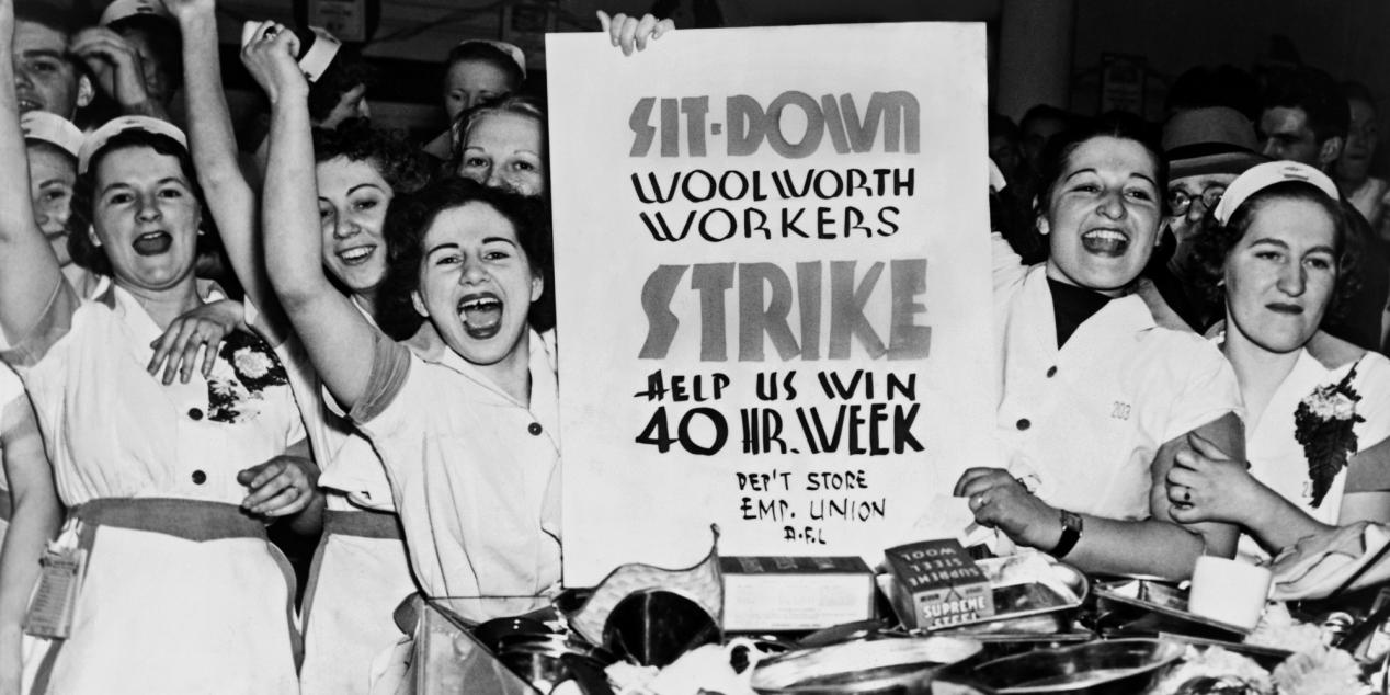 Female employees of Woolworth's holding sign indicating they are striking for a 40 hour work week