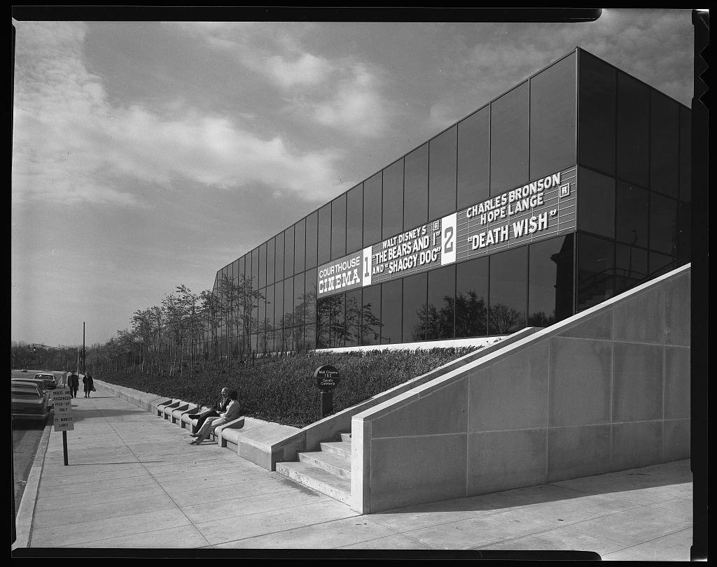 A building with a large dark reflective facade and modernist architectural features.