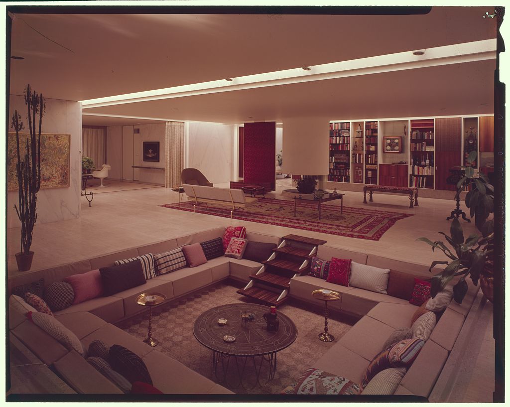 A living area of a home with a recessed seating area and other seating spaces.