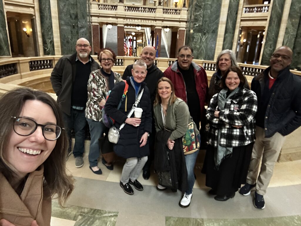 A group of 10 people pose for a selfie in the Wisconsin State Capitol