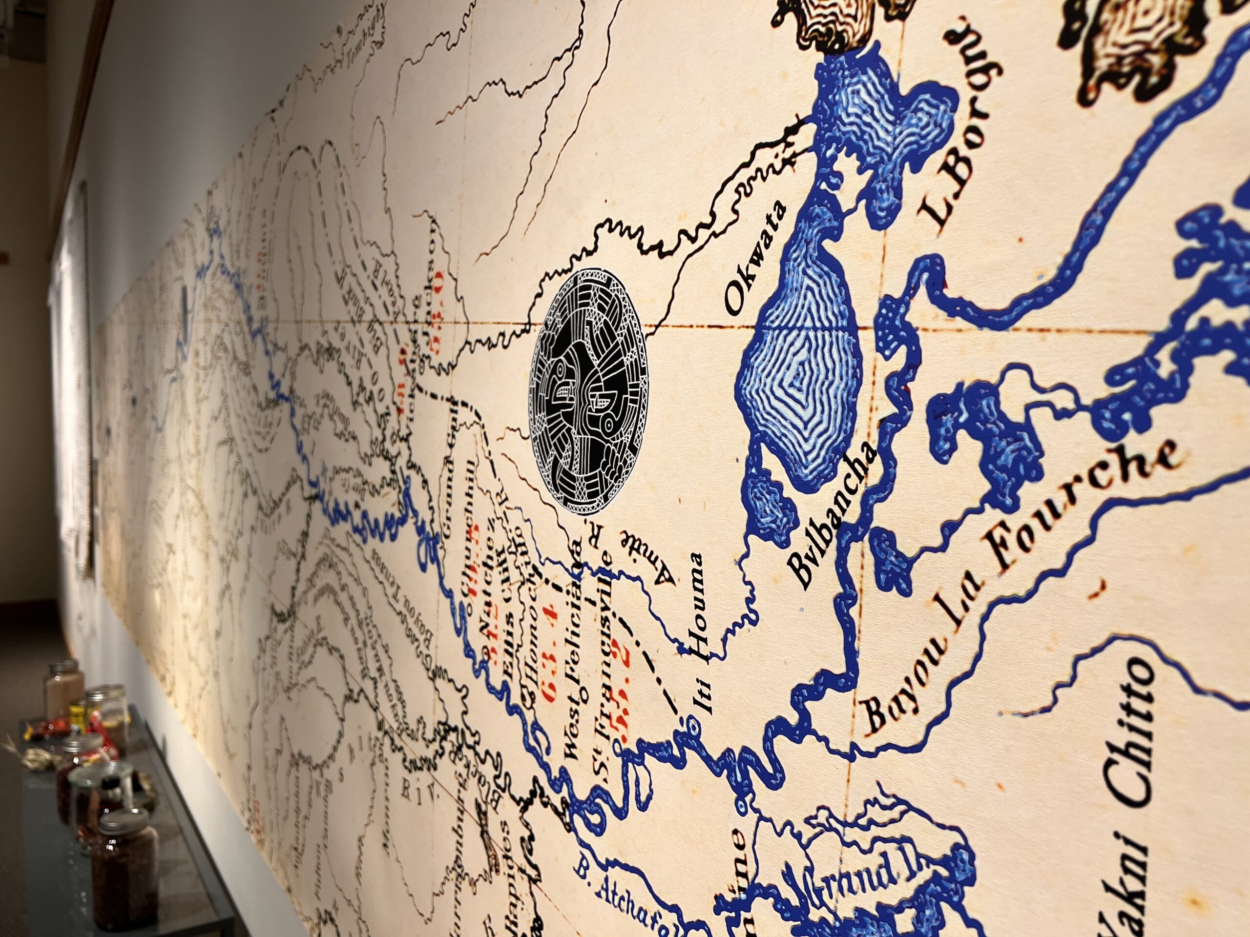A vinyl print of a map of the basins of the Mississippi and tributaries, hung up on a wall.