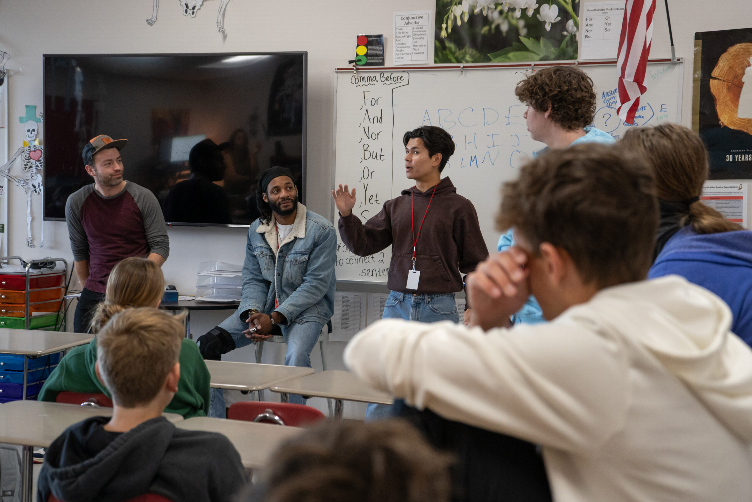 A group of actors in a classroom.