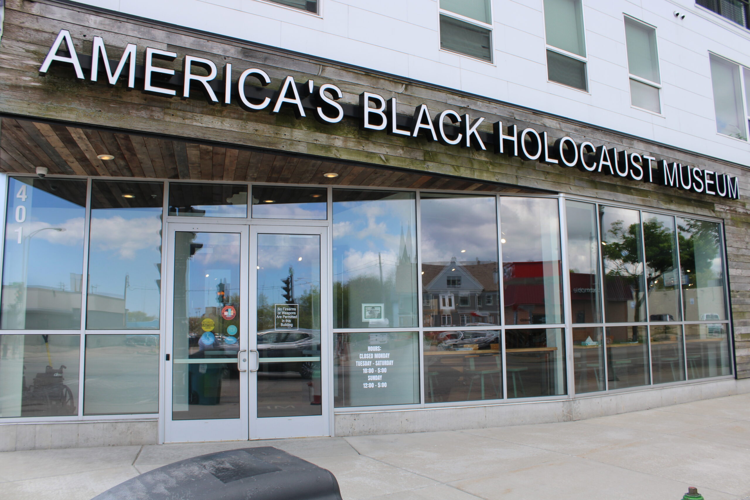 A building facade with large windows and a large signage with letters that read "America's Black Holocaust Museum"