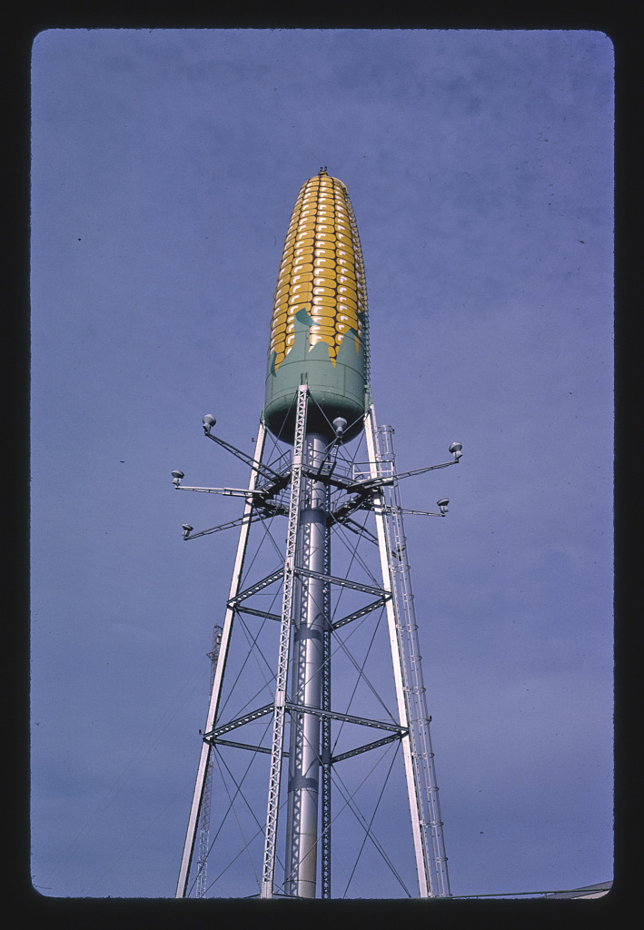 A water tower tank painted to look like a corn cob. The shape of the tank closely mimics the shape of corn.