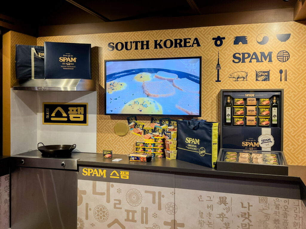 A display labelled "South Korea" with cans of SPAM, ramen boxes, and additional signage in Korean.