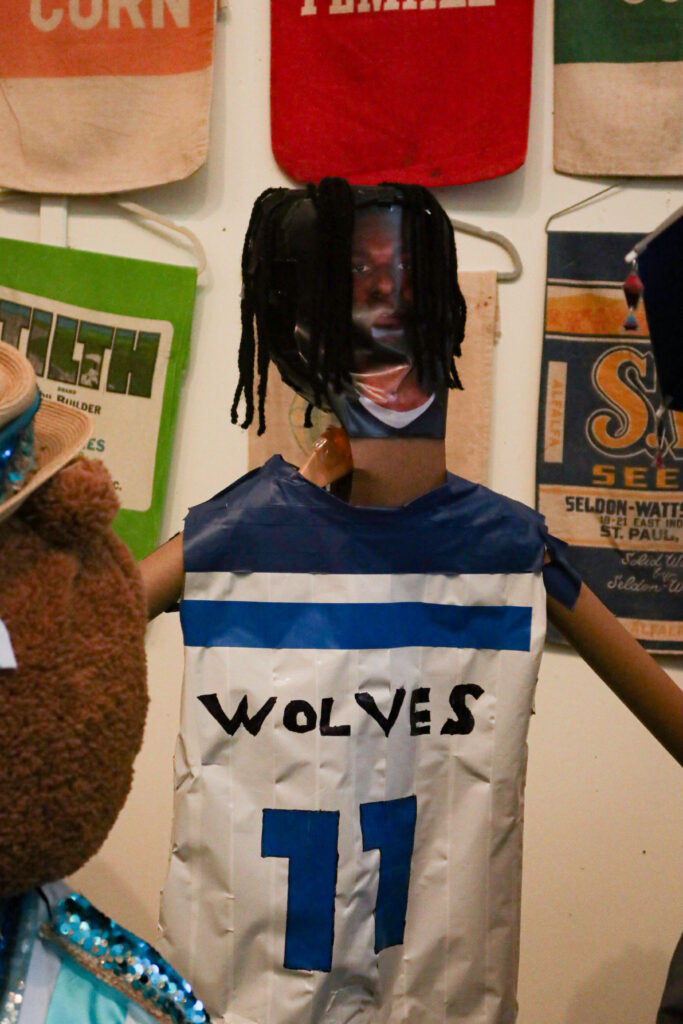 A scarecrow with a photo of Naz Reid's face taped on, with a paper jersey reading, "Wolves; 11"