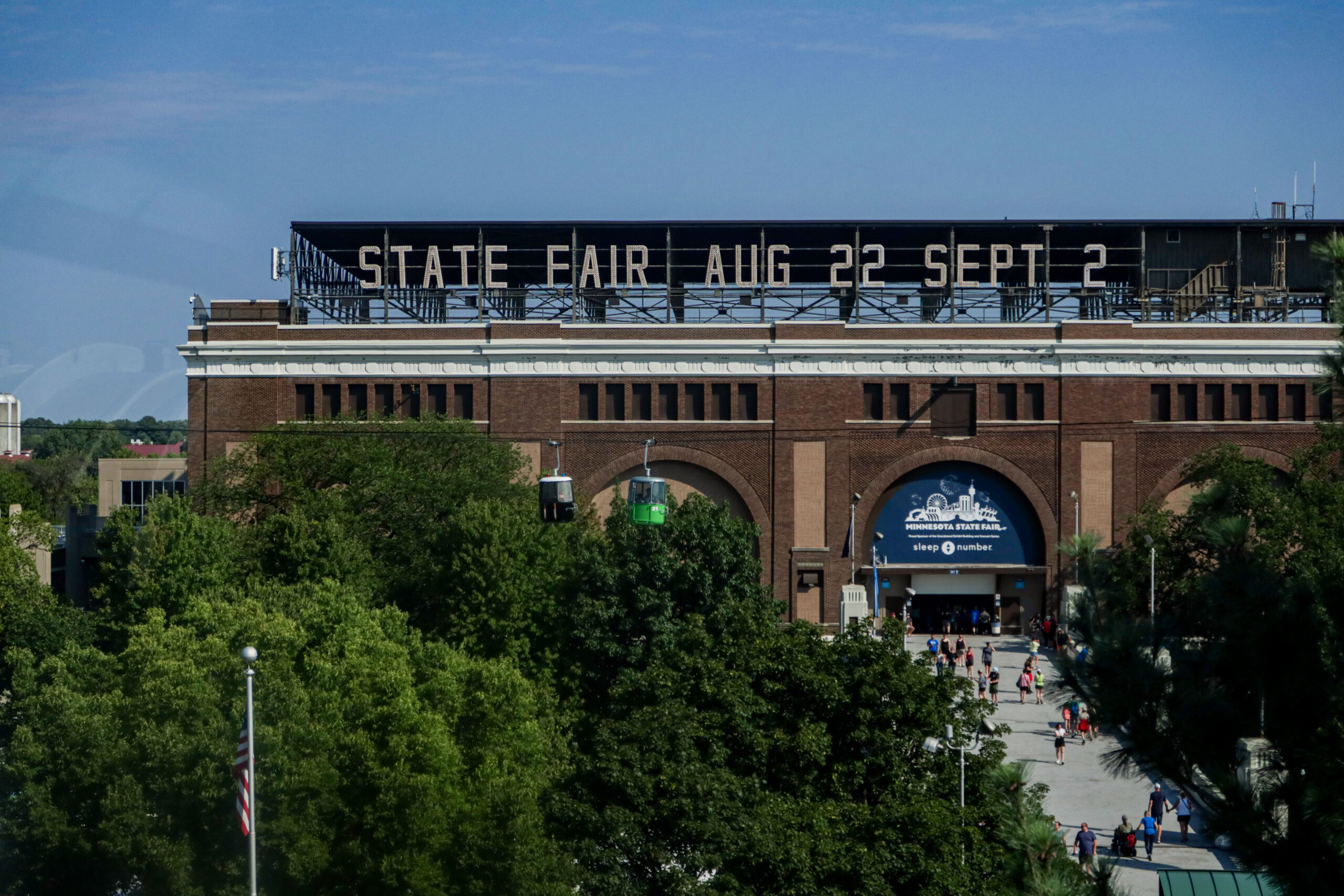 Signage atop a building reading, "State Fair, Aug 22 - Sept 2"