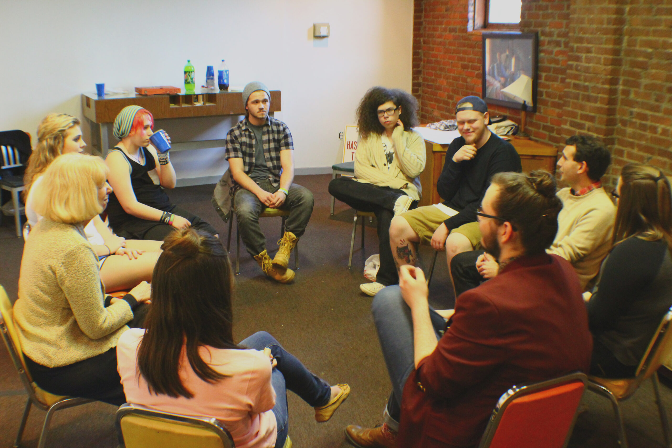 A group of people sitting in chairs arranged in a circle.