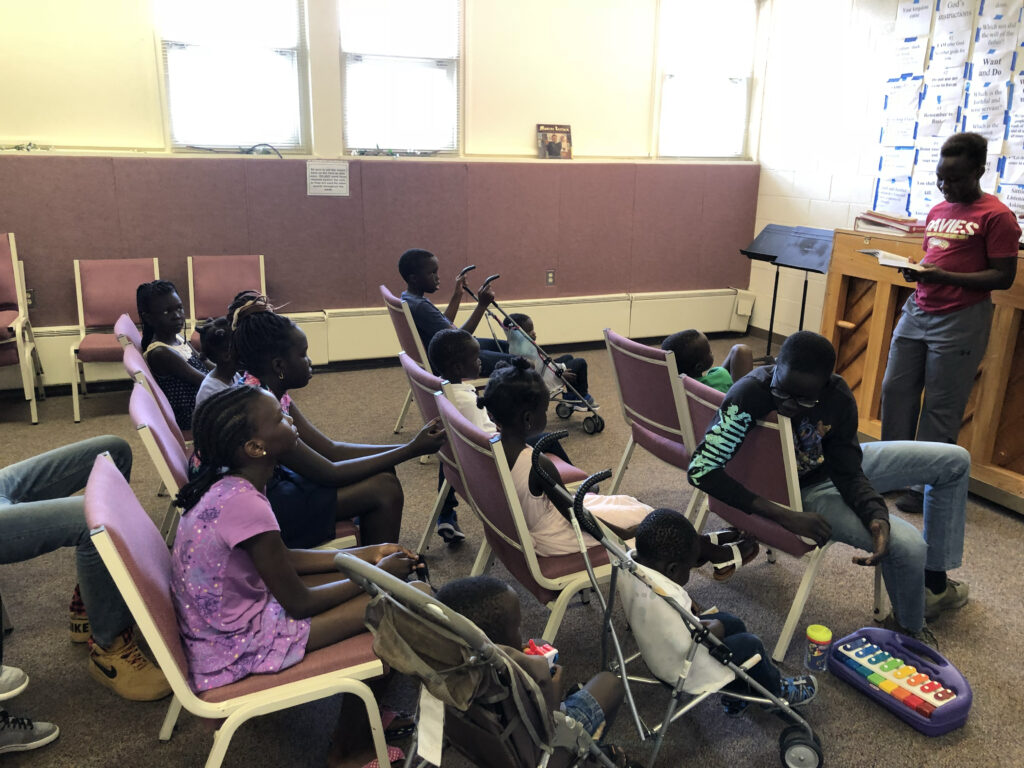 A group of young people with dark skin tone in a classroom