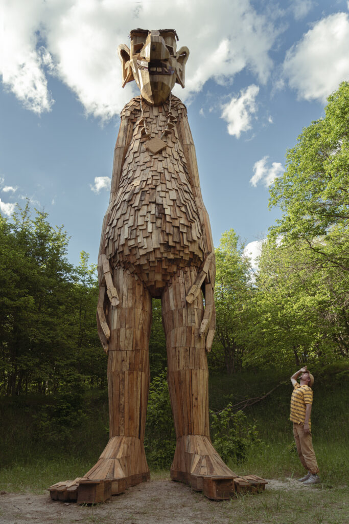 A giant wooden standing troll in the woods