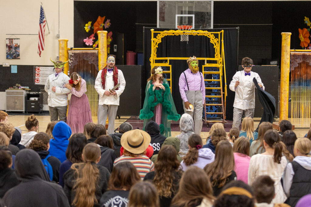 Actors perform a Shakespeare play in a school gym