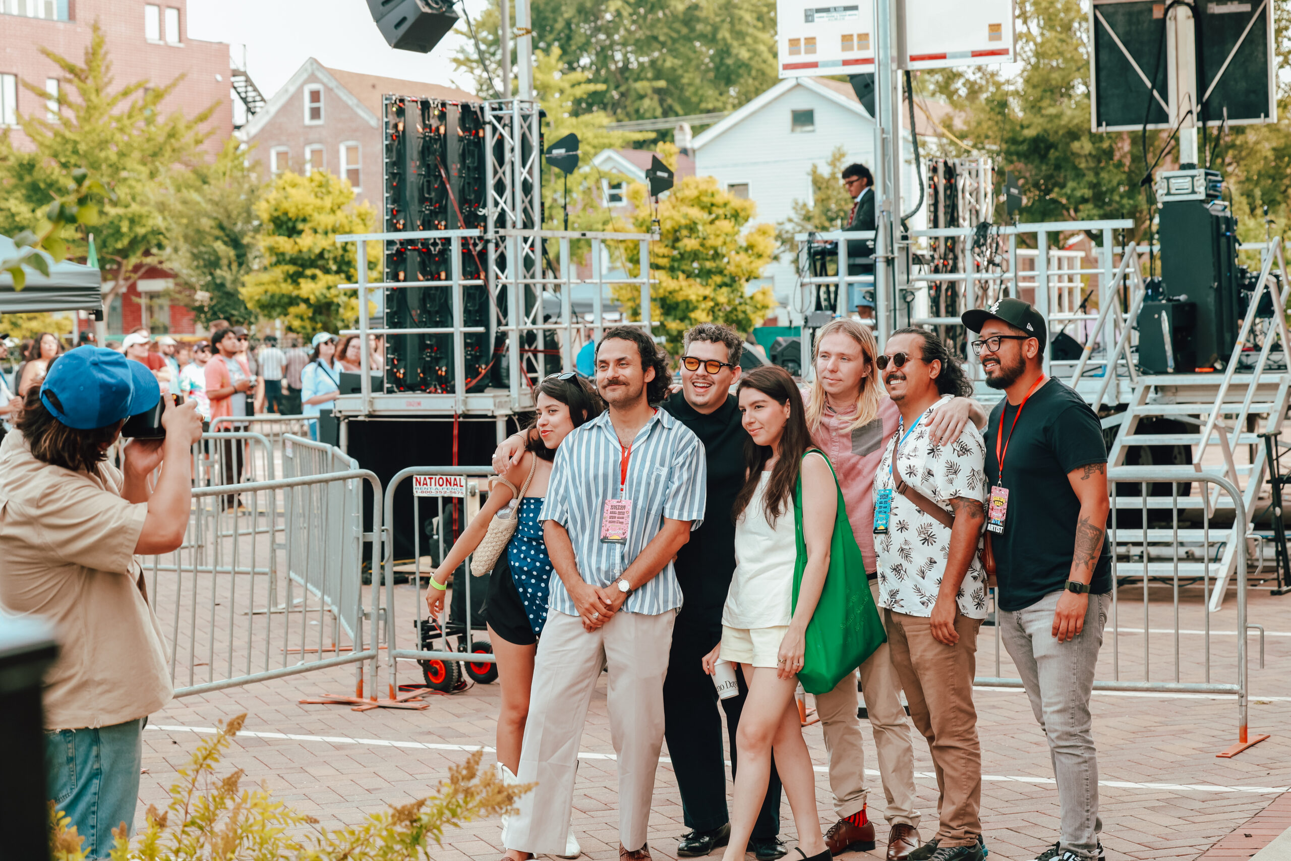 A group of people posing for a photo as a photographer captures them.