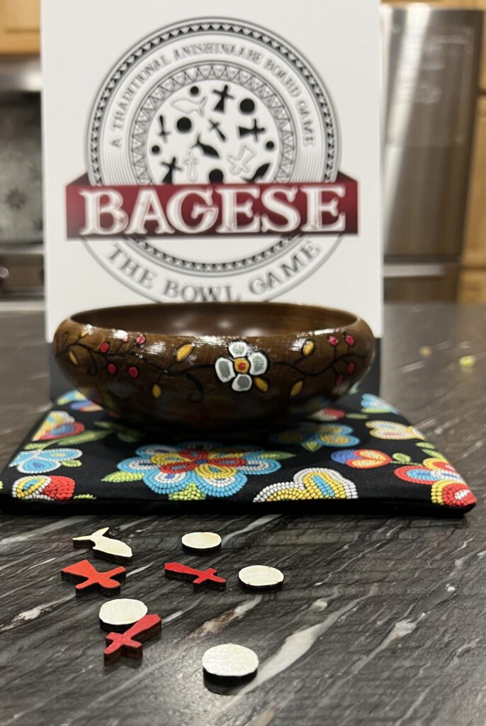 An unpacked board game includes a bowl, a mat, and red and white pieces scattered on a table.