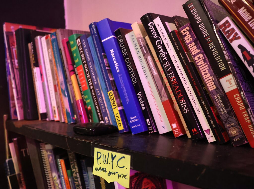 A large stack of books on a shelf.