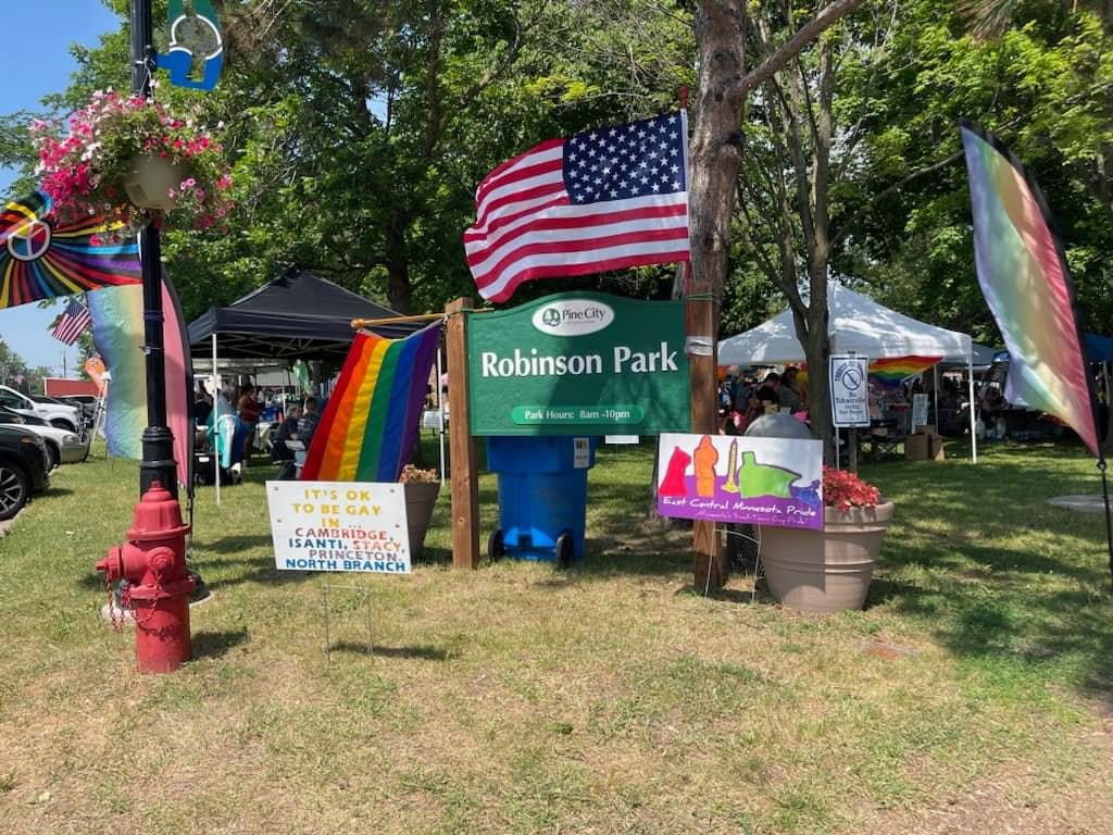 A park with multiple yard signs and flags.