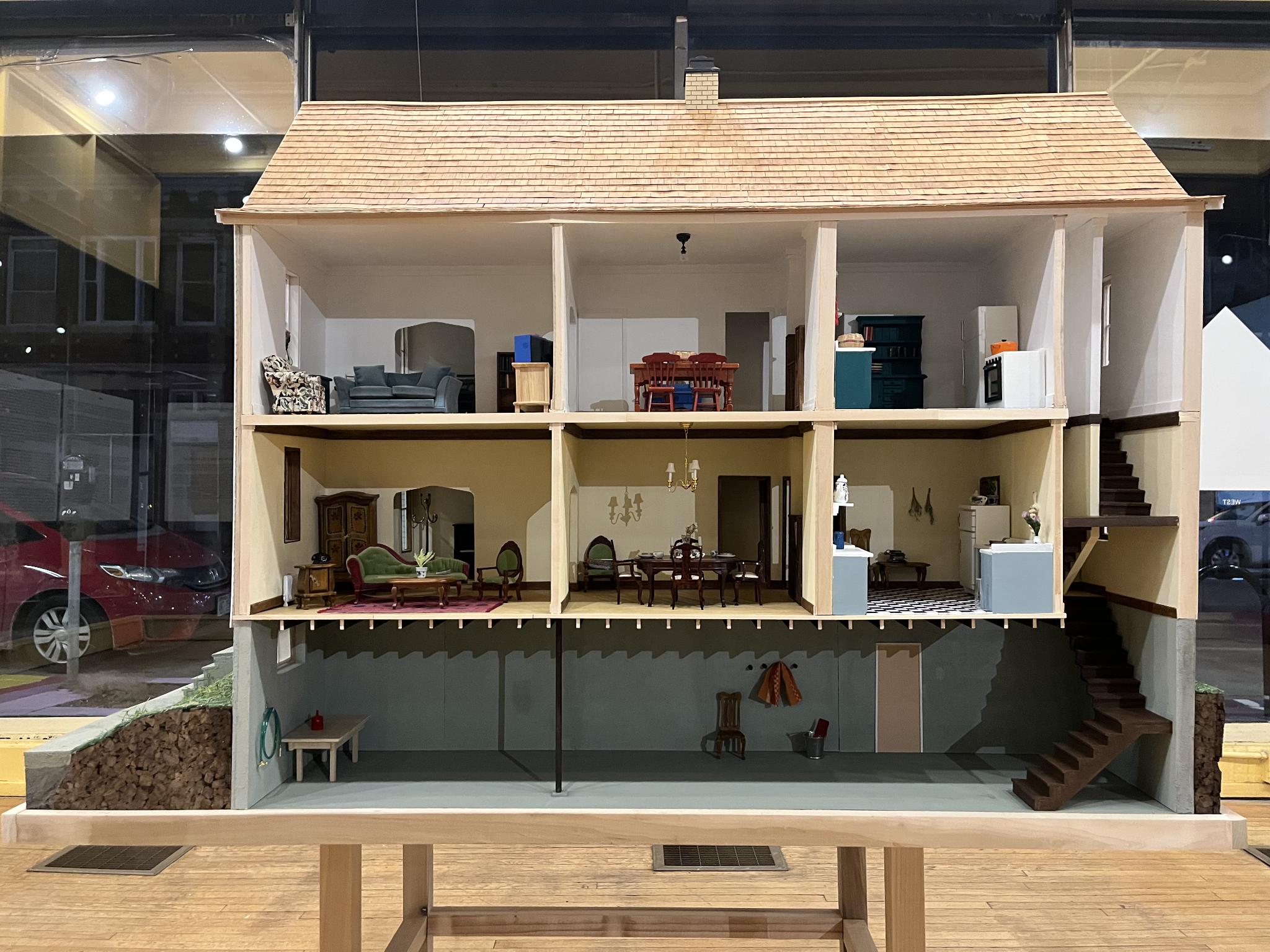 A dollhouse in an art gallery.