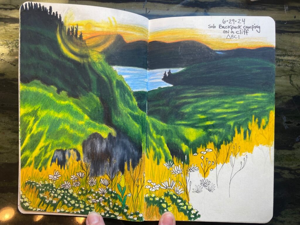 An open sketchbook featuring a nature drawing with greens and yellows.