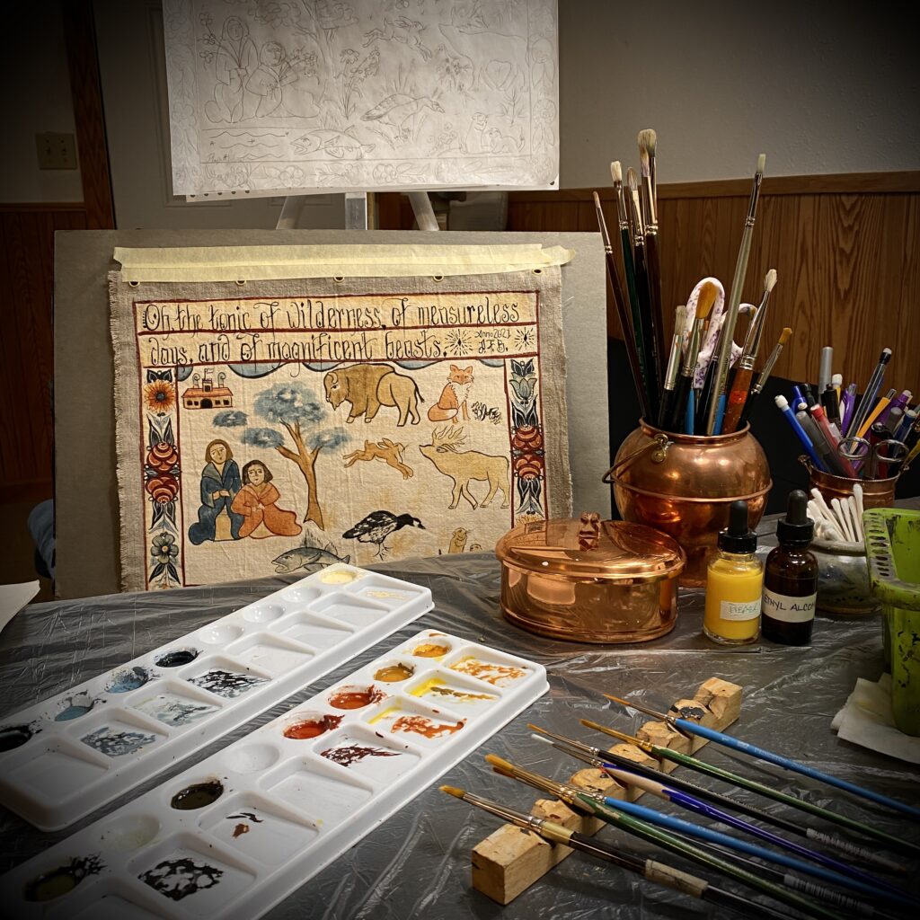 A sketch and unfinished painting depicting outdoor scenes, next to some palettes with paint, dropper bottles, and copper cups holding brushes and other tools.