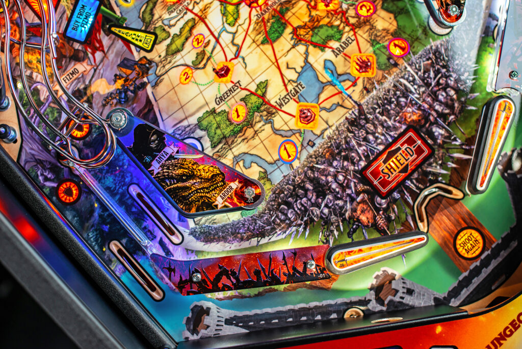 Detailed section of a Dungeons & Dragons pinball playfield with a medieval fantasy map, glowing targets, and painted illustrations of characters like lizardfolk and warriors with swords and shields.
