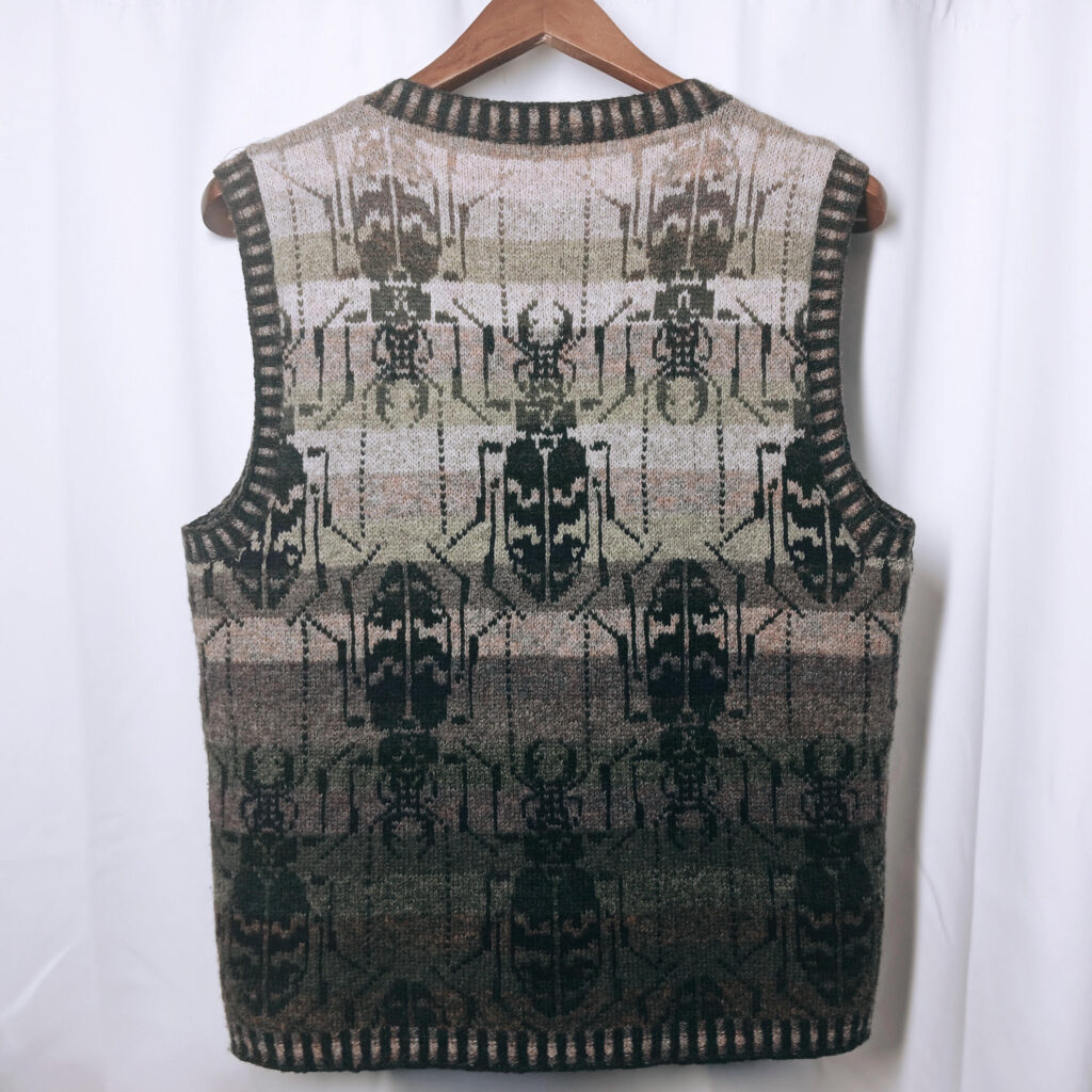 A knitted vest with beetle patterns all over.