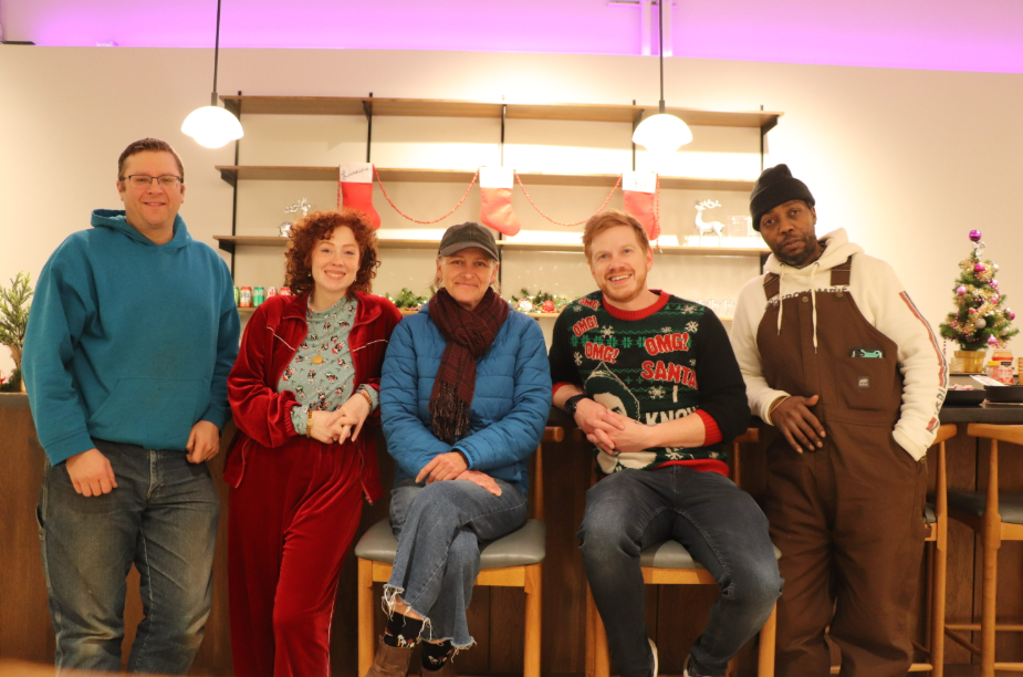 Five people in a room with soft lighting