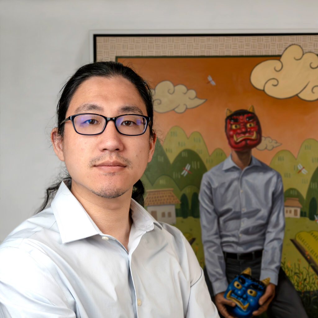 A person with medium skin tone and glasses in front of a painting.