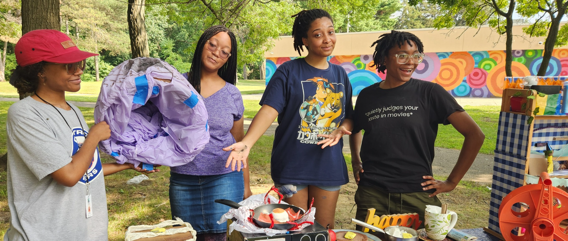 People stand around a table with art.