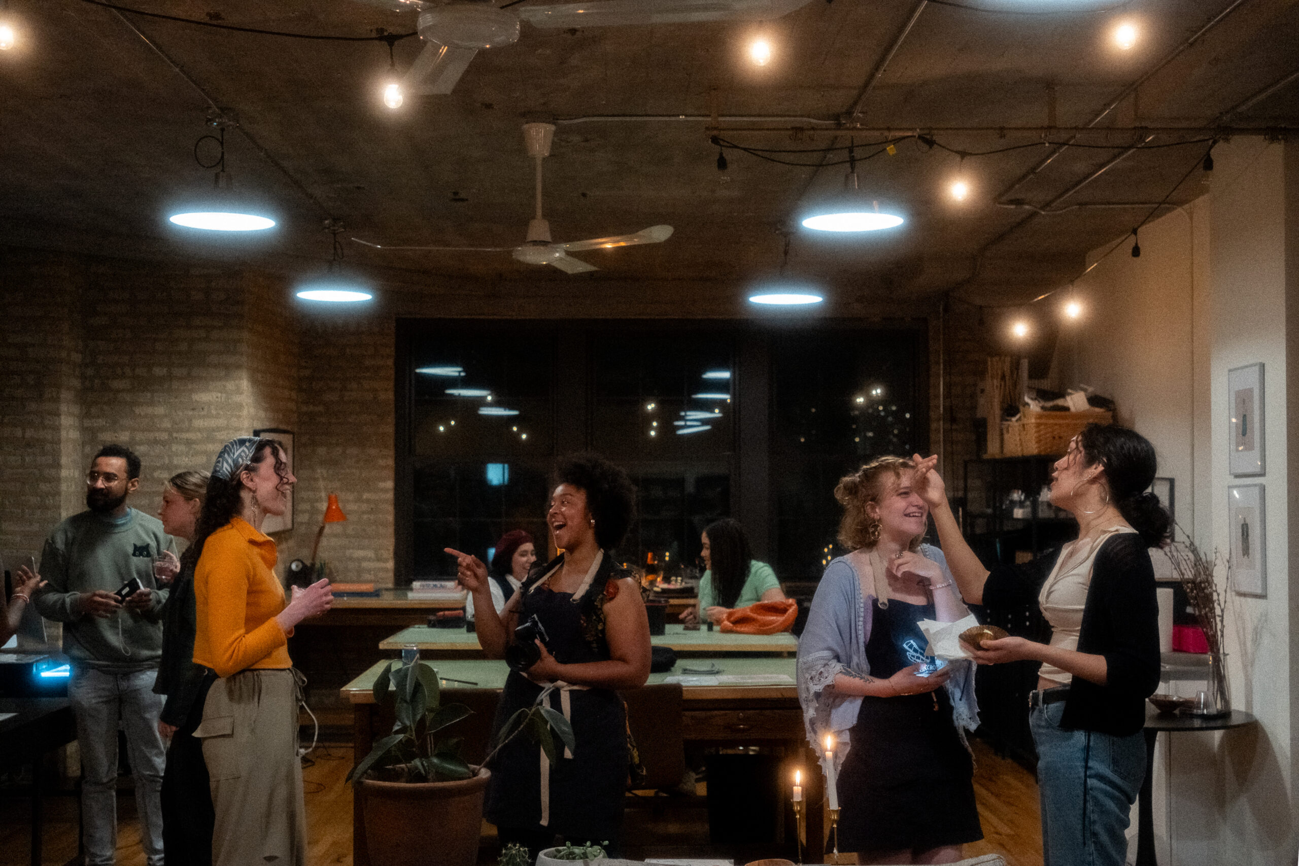 People talking together in a room while standing.