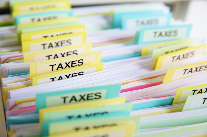 File folders in multiple colors all of which are labelled TAXES