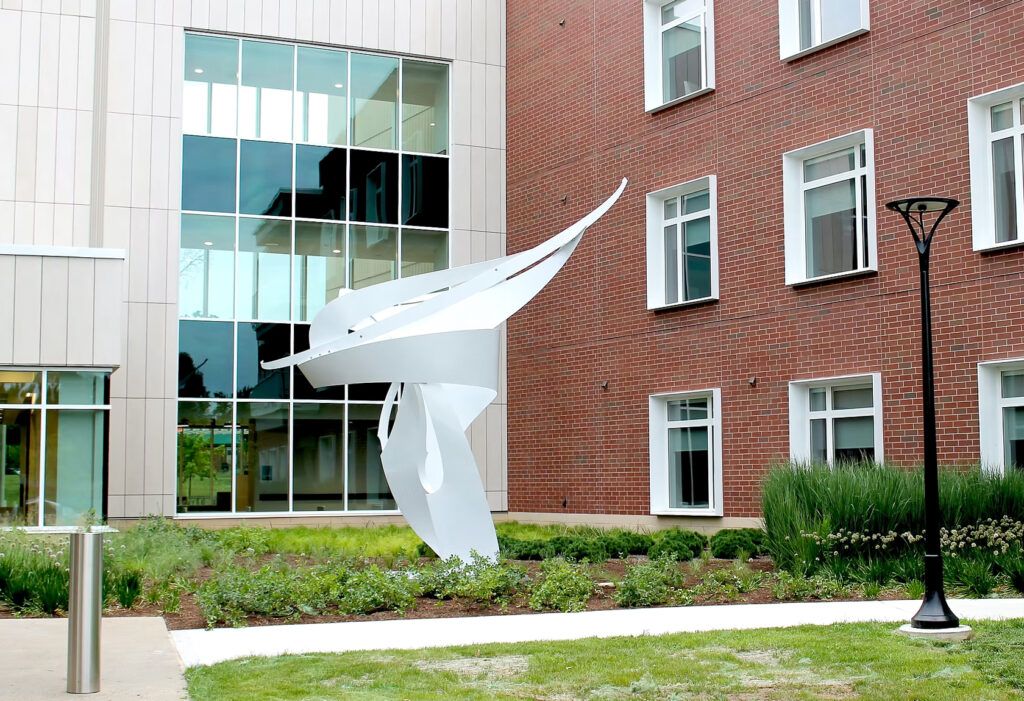An abstract metal sculpture located outdoors.