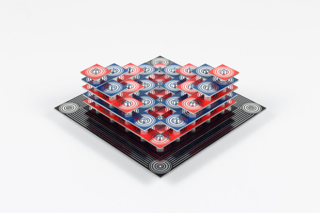 A three-dimensional sculpture of varying blue and red layers, featuring white spiraling circles.